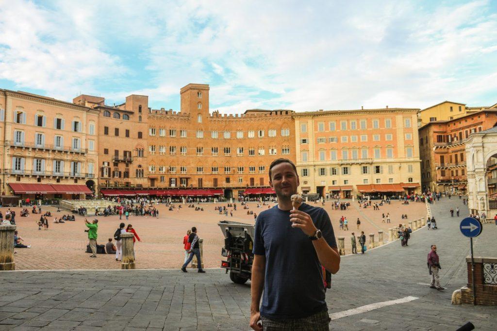 Diego with a gelato and Piazza del Campo in the background